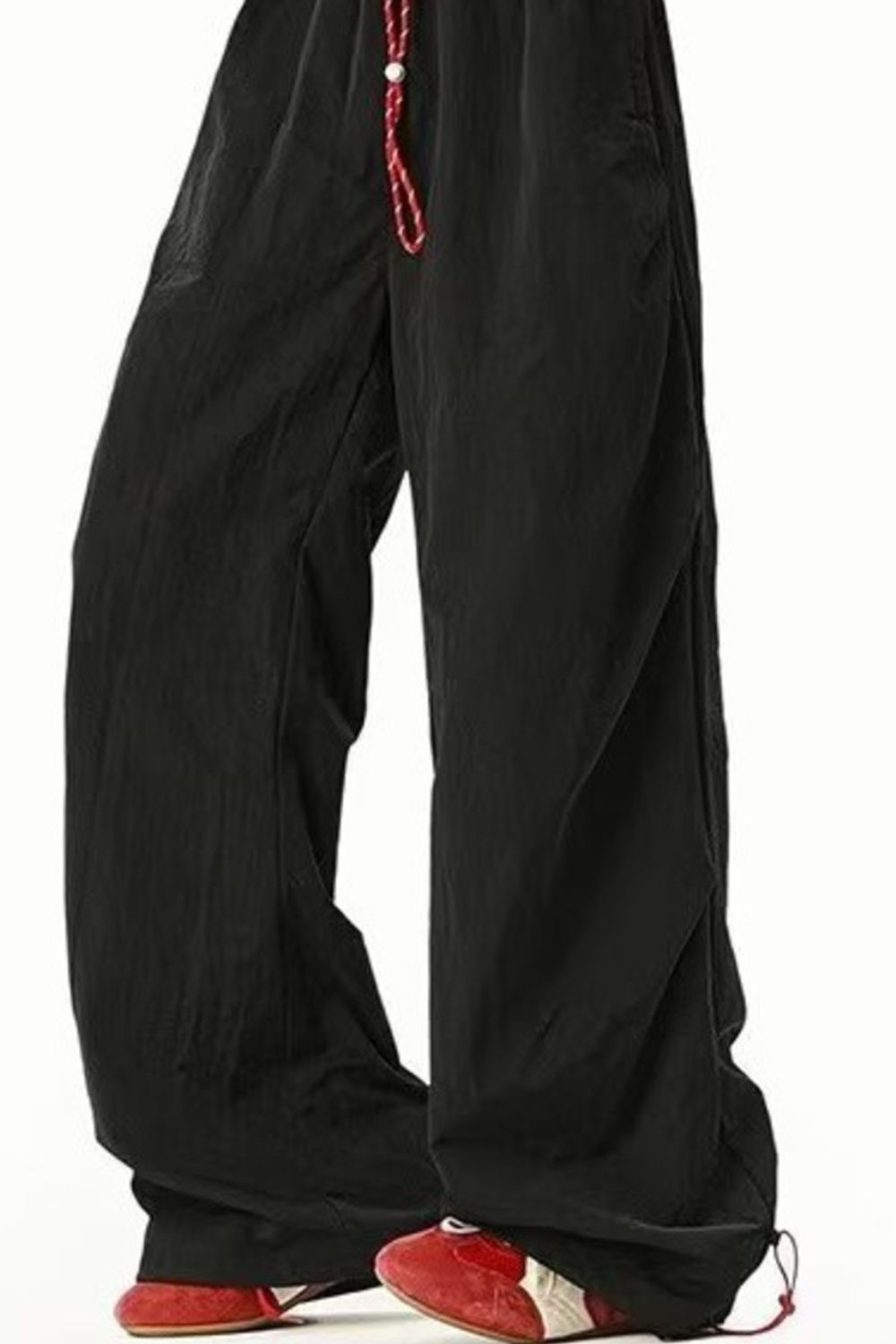 Men's black loose-fit drawstring sweatpants with red drawstring detail.