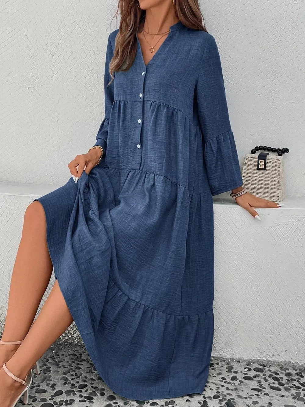 Blue tiered ruffle hem v-neck dress with button front and bell sleeves.