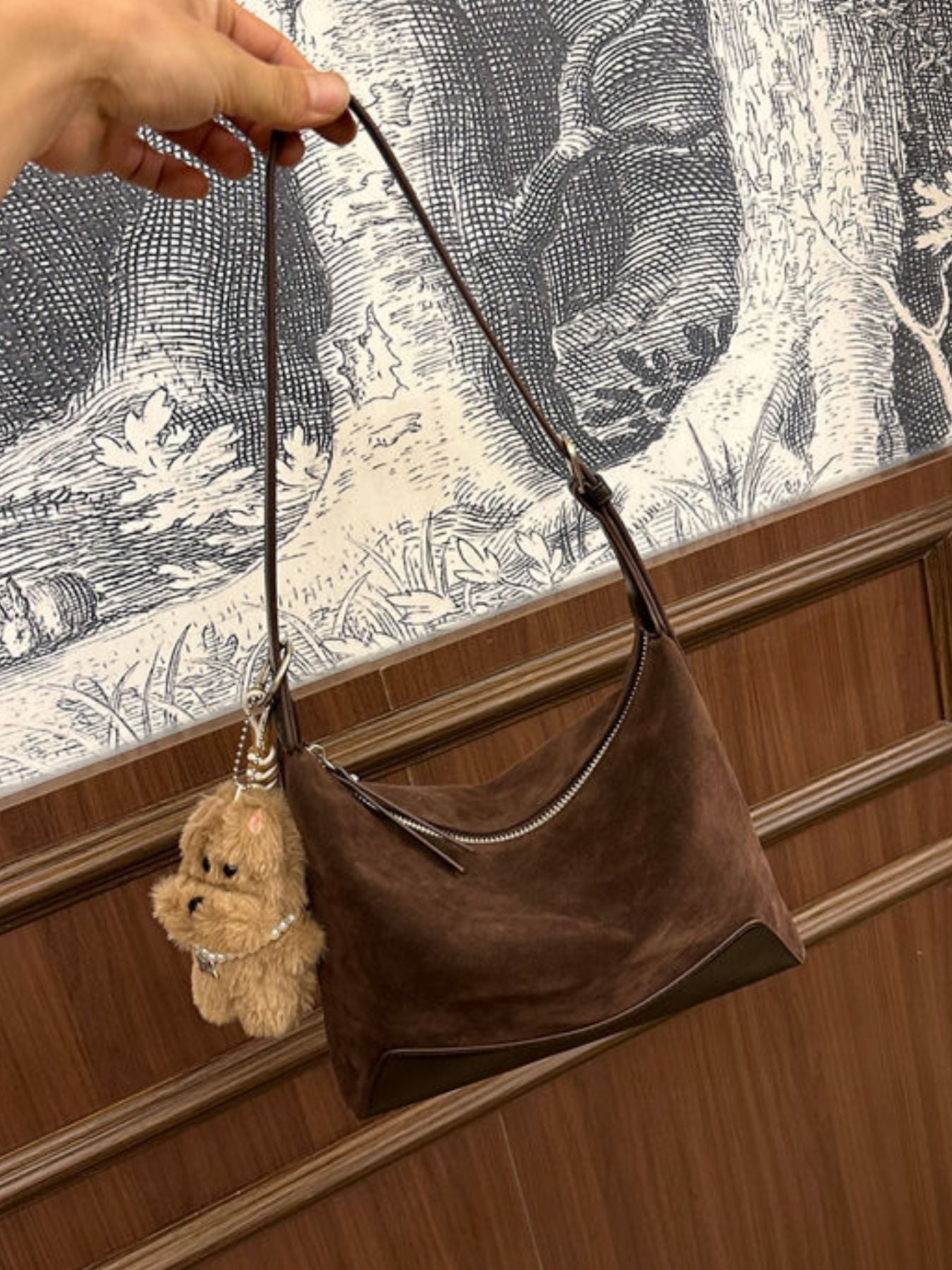 Brown suede crossbody bag with zipper closure and fuzzy bear charm