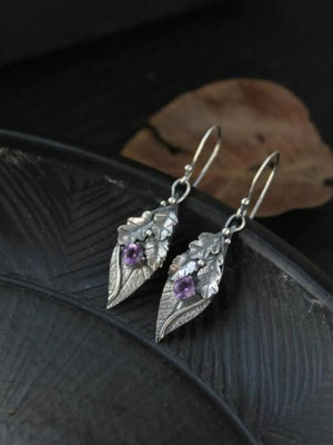 Textured leaf drop earrings with purple stones, boho style.