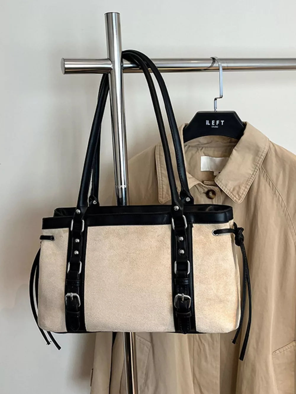 Two-tone suede tote bag with black leather trim and buckle details.