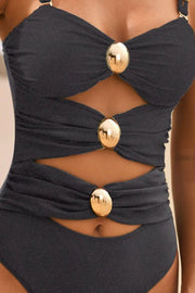 Black one-piece swimsuit with gold button details and cutouts