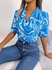 Sky blue swirl print camp collar blouse with short sleeves.