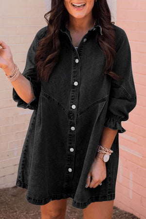 Black denim shirtdress with button front and ruffled cuff detail.