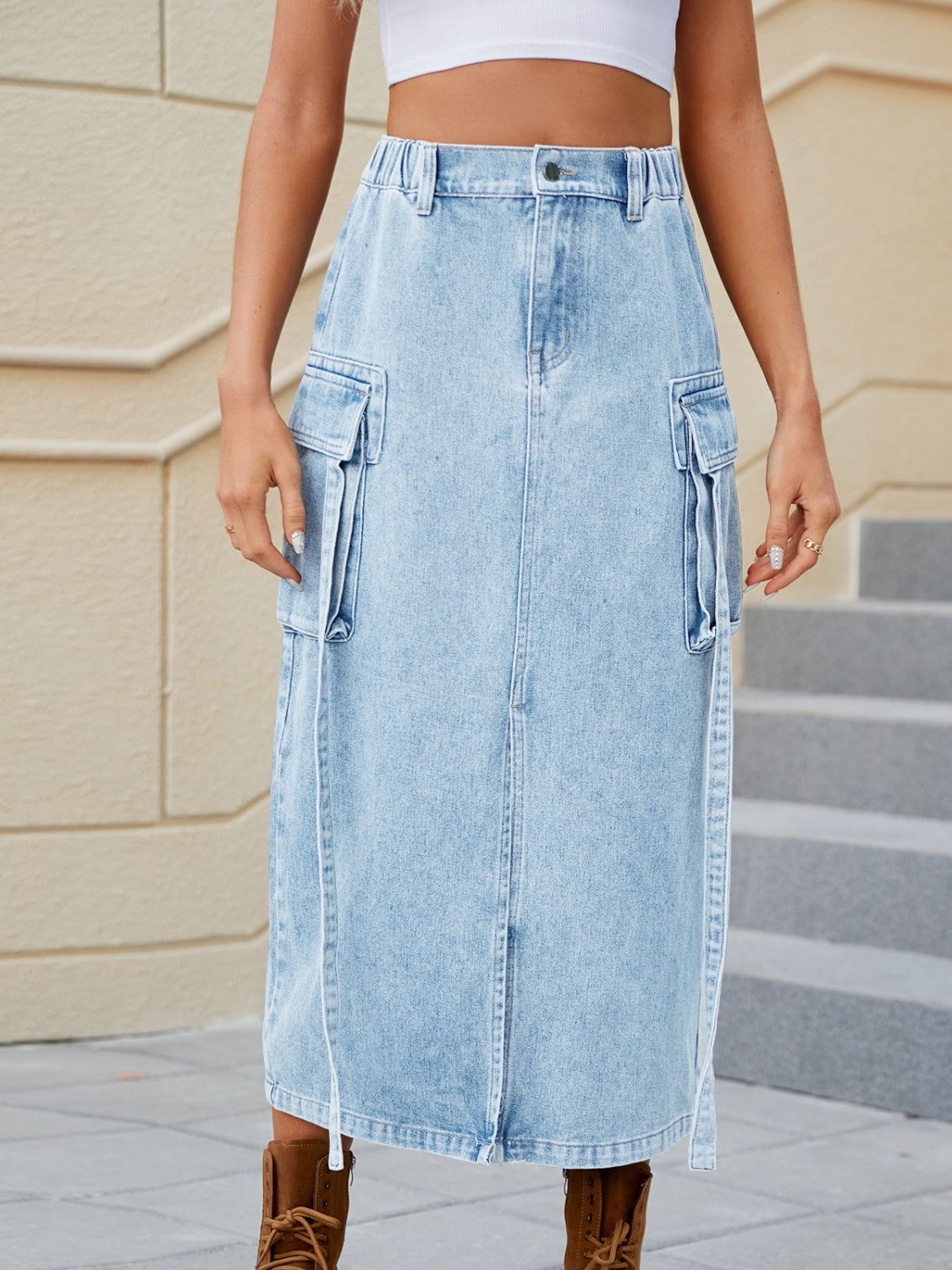 Light blue denim midi skirt with cargo pockets and a front slit.