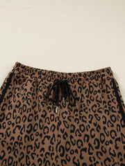 Brown leopard print joggers with drawstring waist and black side stripes.