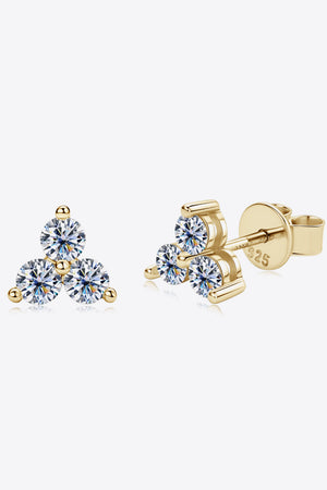 Gold trilogy moissanite stud earrings with three round-cut stones and 925 sterling silver backing.