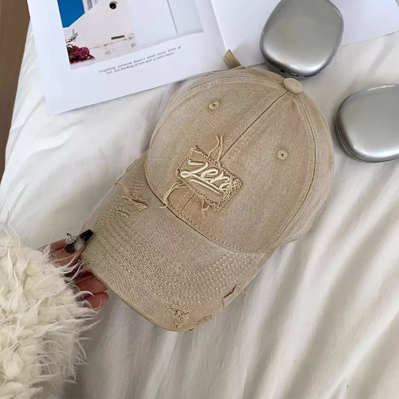 Beige distressed cotton baseball cap with embroidered patch detail