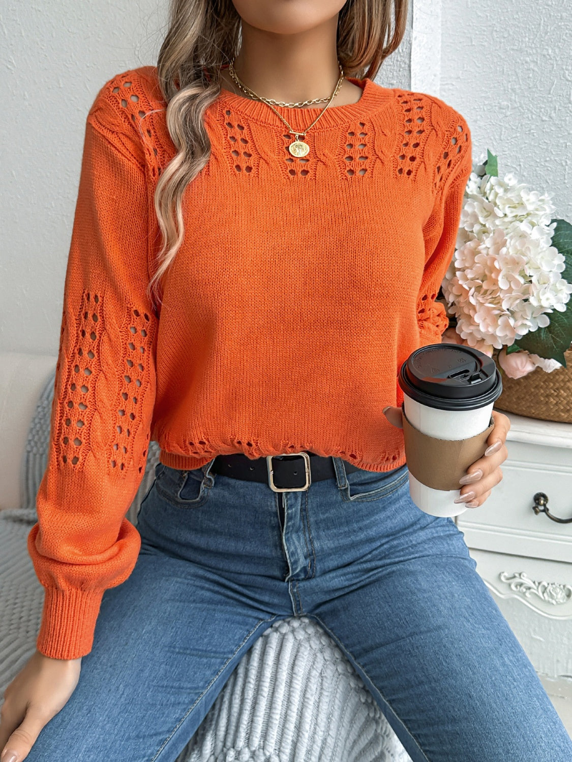 Openwork knit sleeve sweater in gray, pumpkin, or black acrylic.