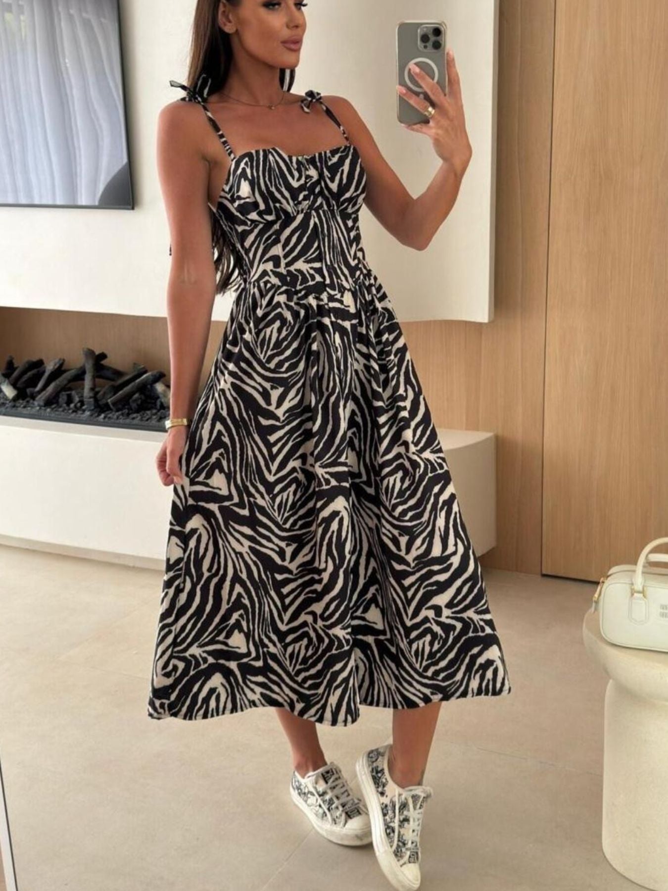 Tie-shoulder midi dress in black and white zebra print with adjustable straps and a-line skirt.