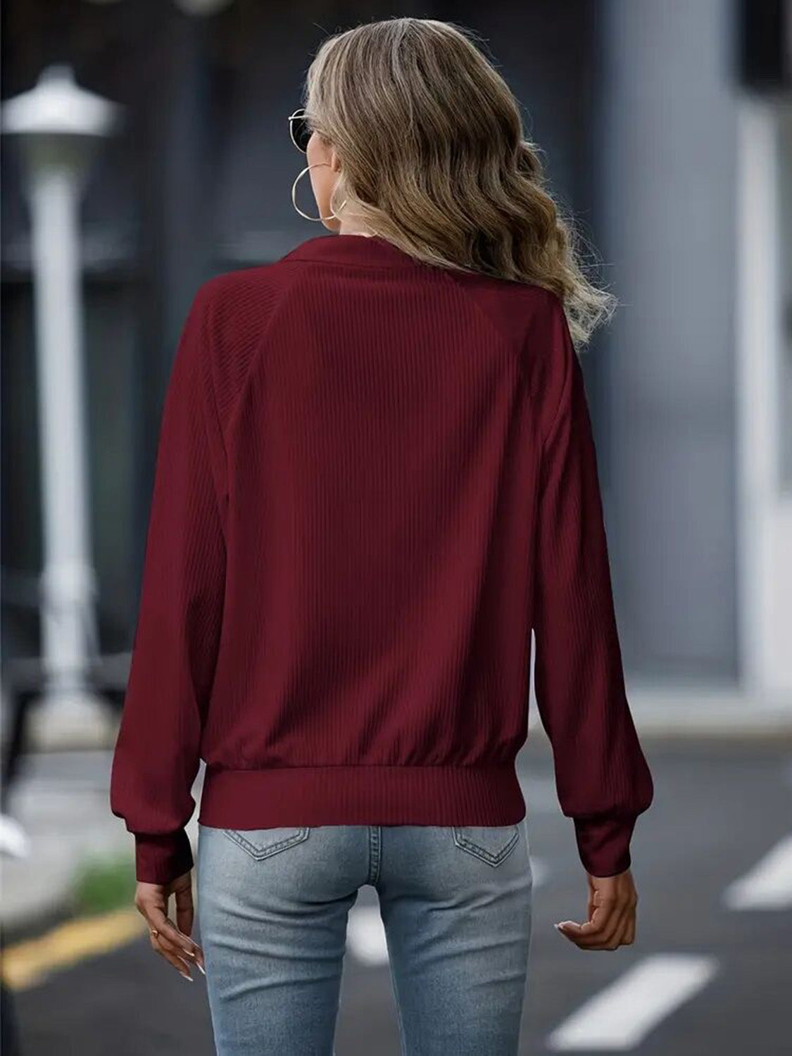 Burgundy textured ribbed raglan zip-up jacket with a mock neck and elastic cuffs.