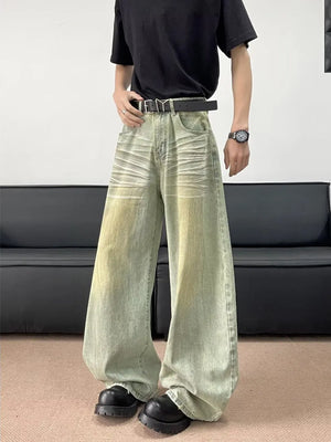 Men's oversized jeans in a light green wash with creasing detail and a relaxed fit.