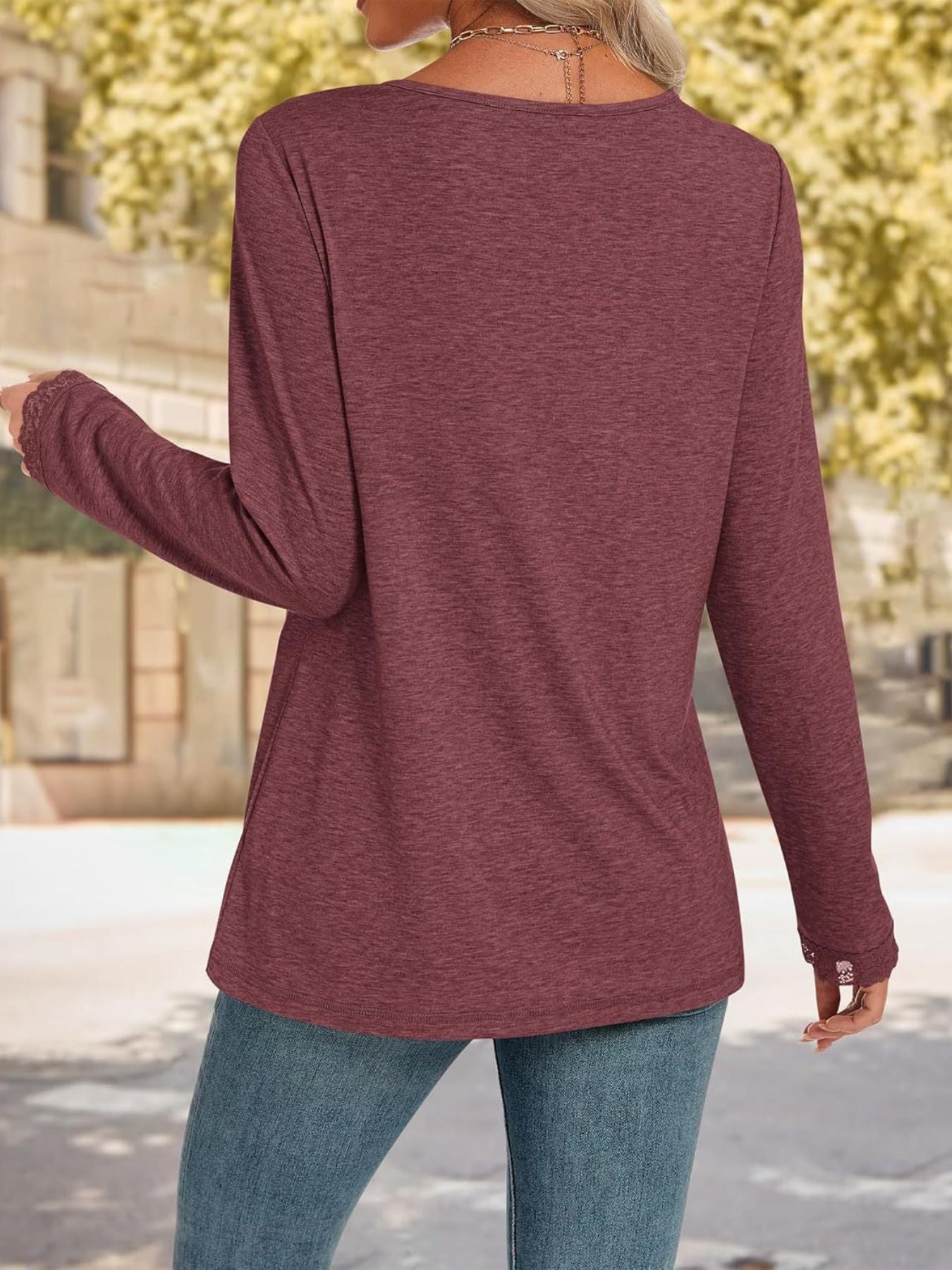 Burgundy long sleeve t-shirt with lace trim cuffs and neckline detail.
