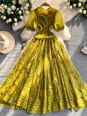 Lace-embellished puff sleeve dress in olive green with button front and ruffled neckline.