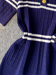 Blue cable knit polo t-shirt with white stripes and gold button detail.