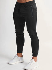 Black slim fit tech joggers with zip pocket and drawstring waist.