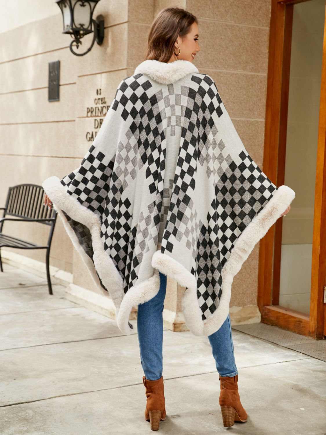 Diamond checkered poncho in ivory with faux fur trim and collar.