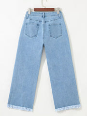 Medium wash denim cropped wide-leg jeans with frayed hem.