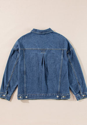 Oversized denim trucker jacket in medium blue with button details and a pleated back yoke.