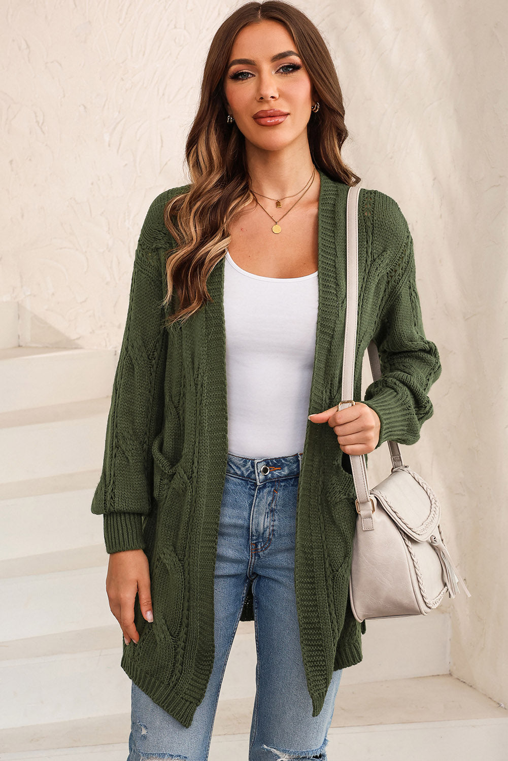 Matcha green cable knit open-front cardigan with pockets.