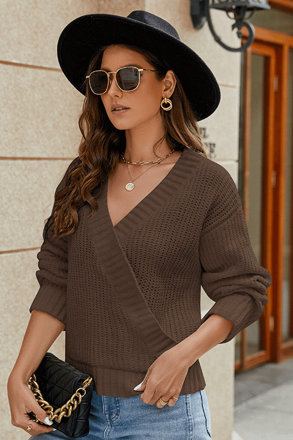 Brown wrap knit v-neck pullover sweater with a textured knit and relaxed fit.