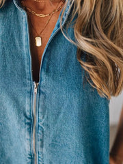 Denim romper with zipper closure and layered necklaces.