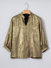 Gold crinkled blouse with 3/4 sleeves and notched V-neck.