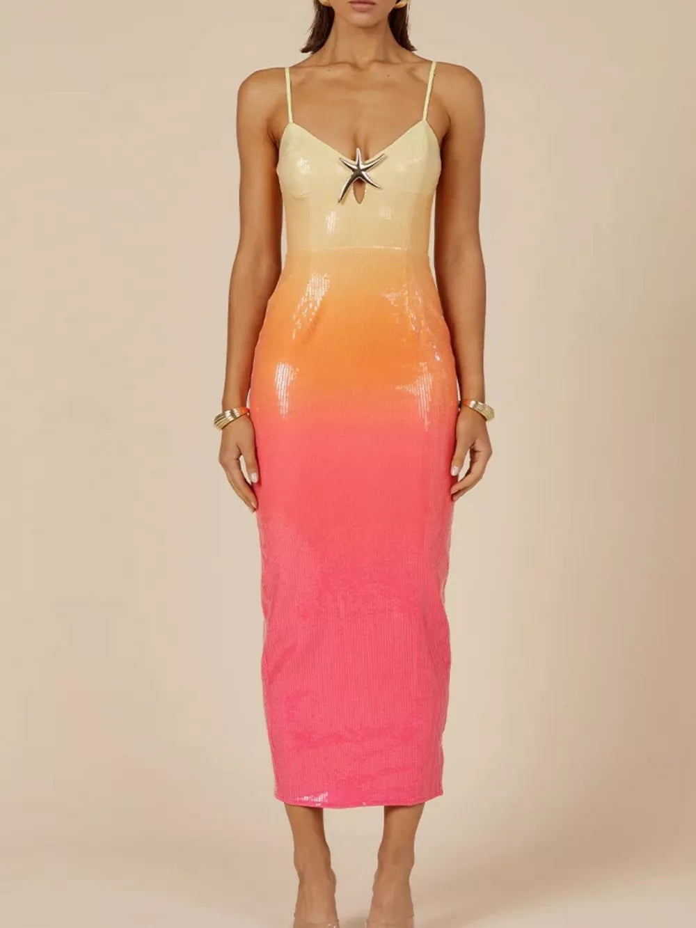 Sequined cami dress with starfish detail and orange to pink gradient.