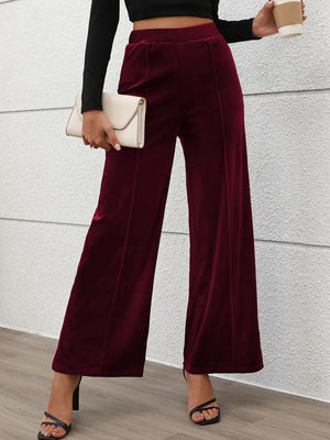 Burgundy velvet palazzo trousers with seam detail and wide leg