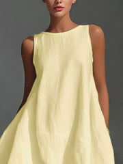 Asymmetrical sleeveless flowing dress in pastel yellow, white, or dark navy.