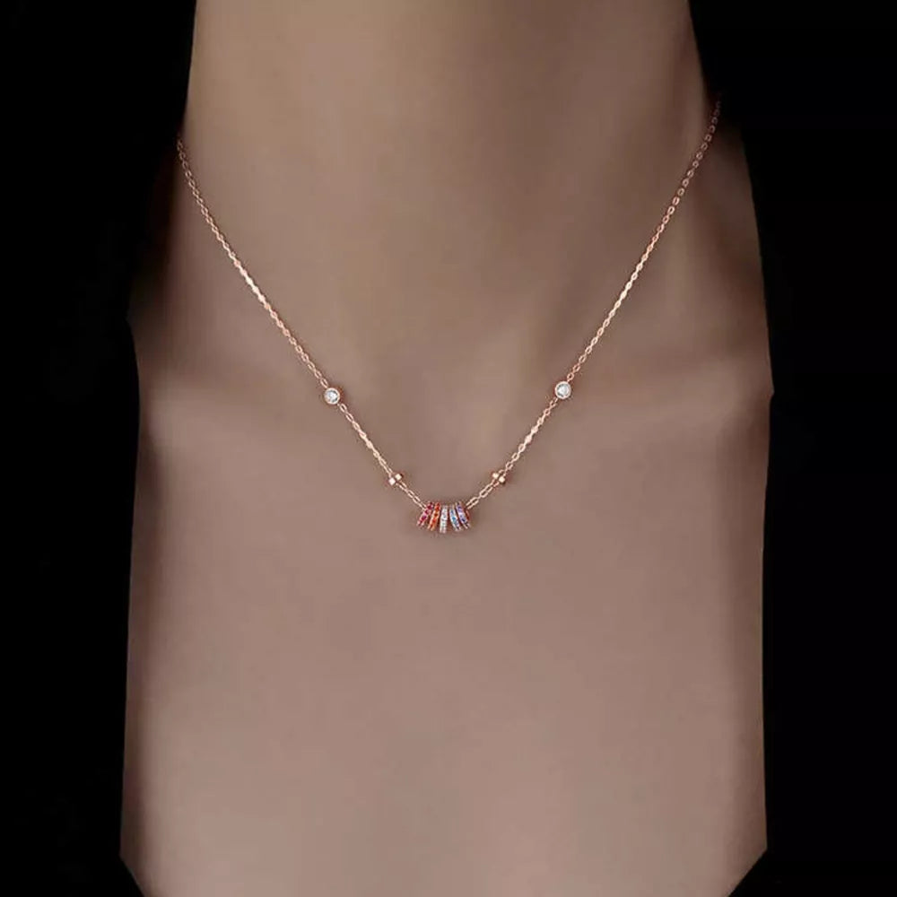 Rose gold necklace with bezel-set zircon cluster pendant and small clear stones