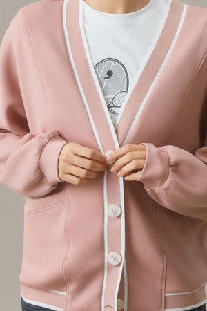 Dusty pink cocoon cardigan with white varsity trim and button closure.