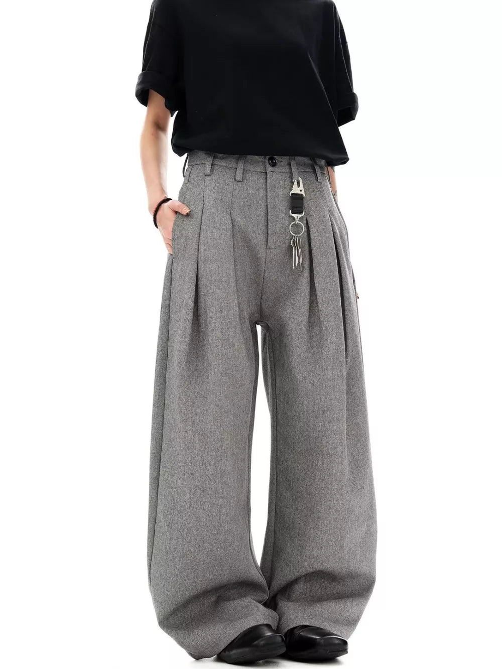 Grey wide-leg pleated sweatpants with a key chain detail at the waist.