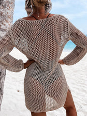 Khaki open-knit beach dress with long sleeves and side slits, worn over swimwear.