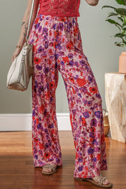 Painterly floral palazzo trousers in strawberry with a wide leg and comfortable fit.