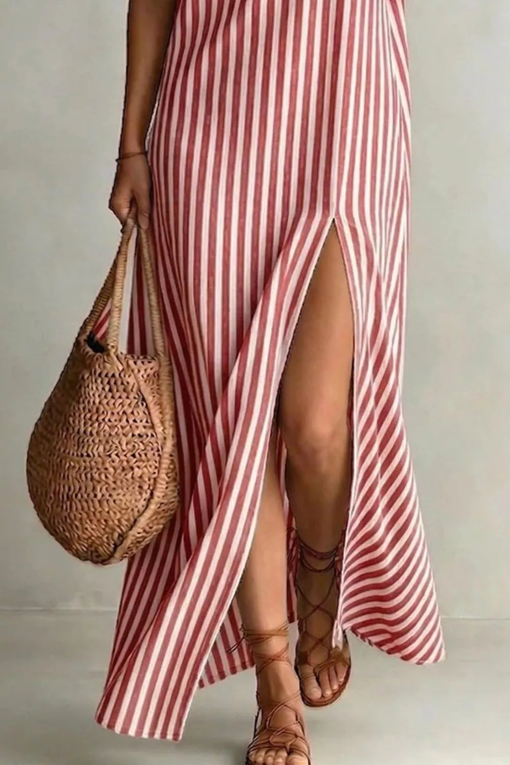 Burnt coral striped maxi dress with V-neck and high slit, worn with gladiator sandals.