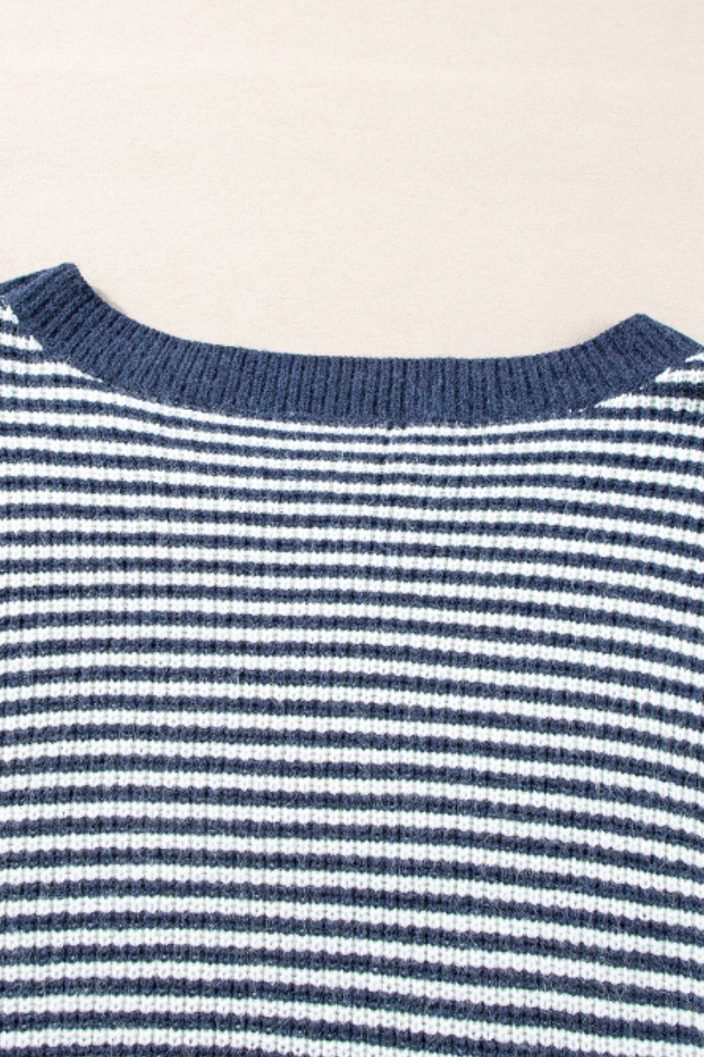 Blue and white striped knit pullover sweater with a crew neck.