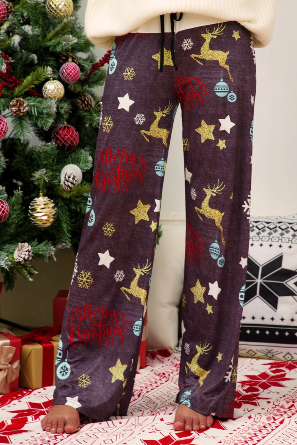 Festive print wide-leg lounge trousers in dusty purple with reindeer, stars, and Merry Christmas text.
