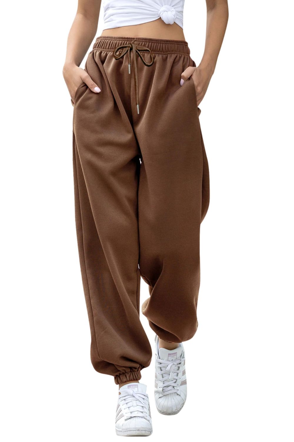 Relaxed-fit cuffed sweatpants in coffee brown with drawstring waist and pockets.