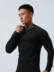 Black long sleeve mock neck compression activewear top with white logo detail