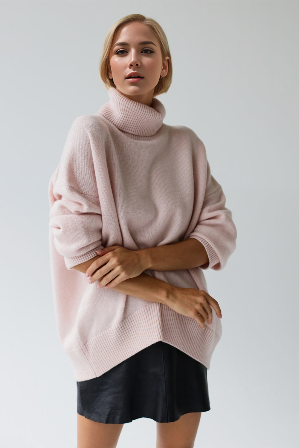 Oversized blush pink cashmere turtleneck cocoon sweater with ribbed cuffs and hem
