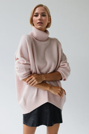 Oversized blush pink cashmere turtleneck cocoon sweater with ribbed cuffs and hem