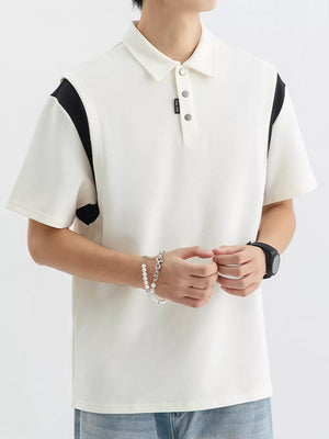 Men's beige cotton polo shirt with contrast black shoulder panels and buttoned placket.