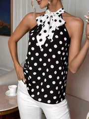 Black polka dot cami with a white polka dot bow tie neck and halter straps.