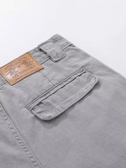 Grey cargo capris with distressed pocket detail and leather patch.