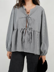 Tie-front peplum blouse with voluminous sleeves in black and white gingham.