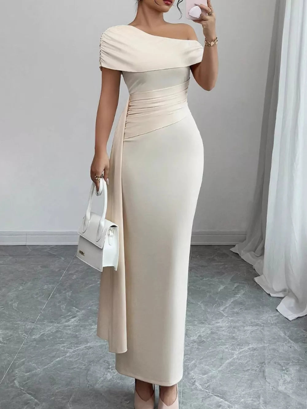 Chic asymmetrical ruched maxi dress in apricot with off-the-shoulder neckline and draped detail.