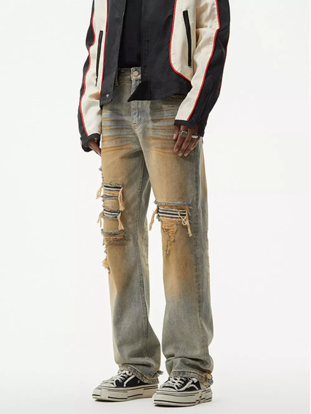 Men's distressed light wash jeans with unique fading and ripped details.