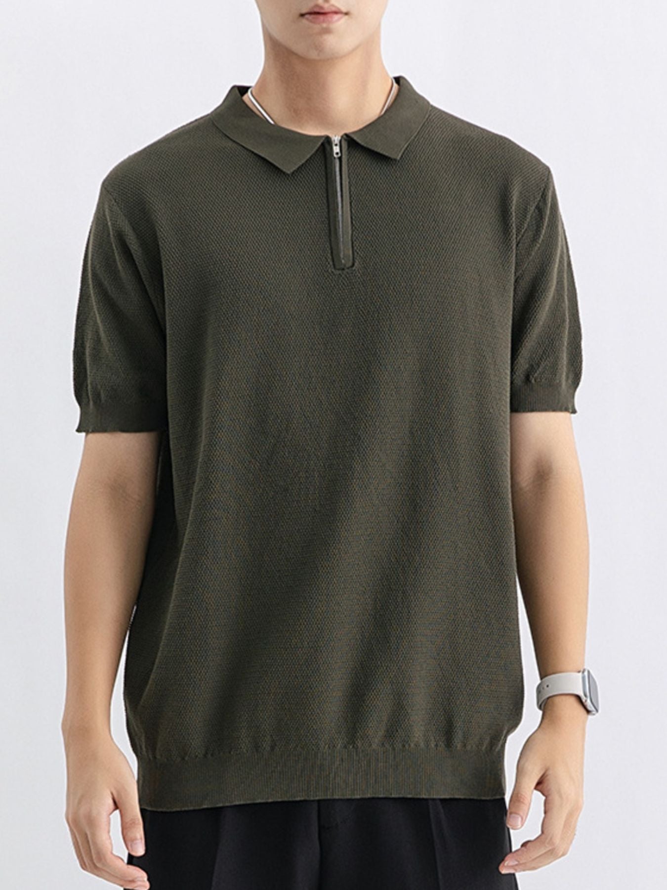 Men's textured knit zip-up polo shirt in army green with short sleeves and a spread collar.