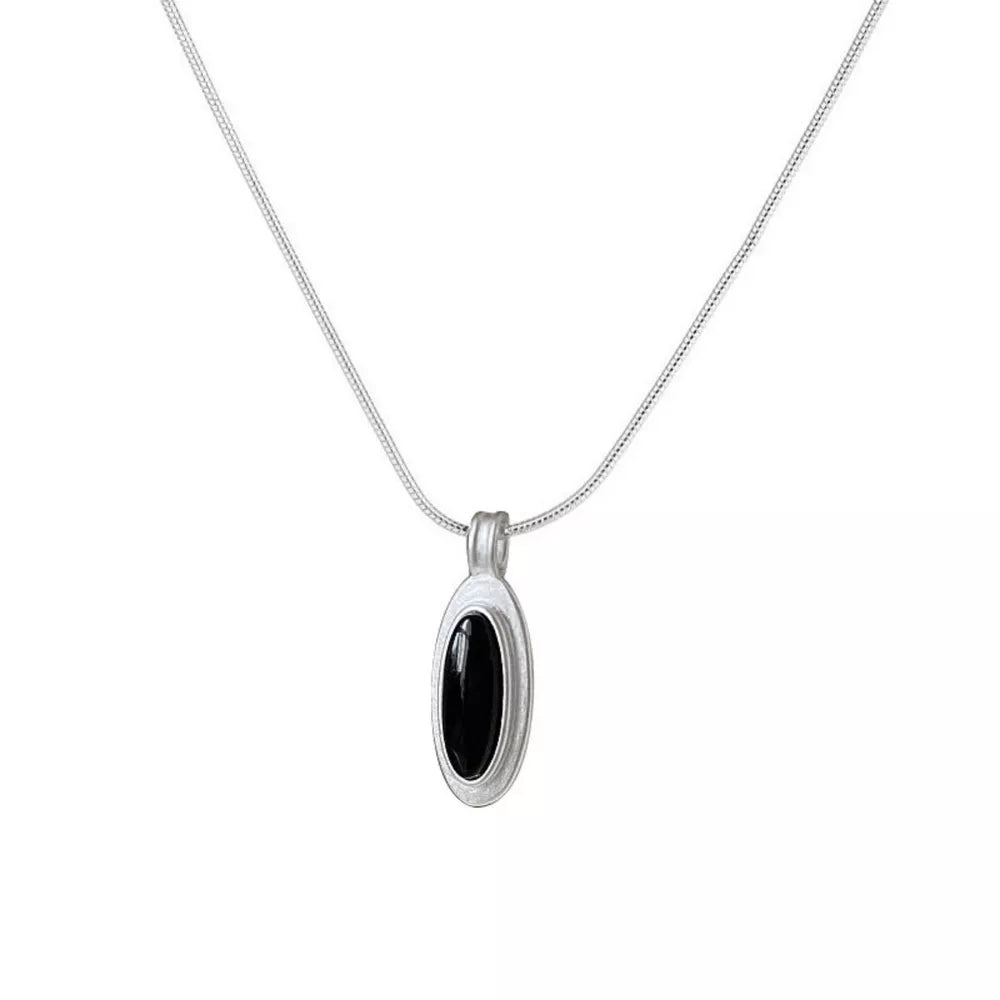 Geometric agate pendant necklace in brushed silver with black stone inlay.